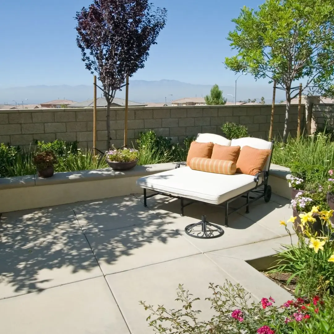 Patio with lounge chair and plants.